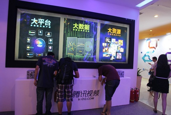 Tencent Inc's video services booth at an Internet conference in Beijing. Tencent will use its social networking tools to attract more traffic to its video services.[Zhu Xingxin for China Daily]  