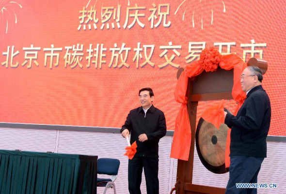 Xie Zhenhua (R), deputy head of China's National Development and Reform Commission, and Beijing Mayor Wang Anshun attend the inaugural ceremony for Beijing's carbon emission trading in Beijing, capital of China, Nov. 28, 2013. Beijing launched carbon emissions trading on Thursday, making it China's third market for compulsory carbon trading. (Xinhua/Hu Qingming) 