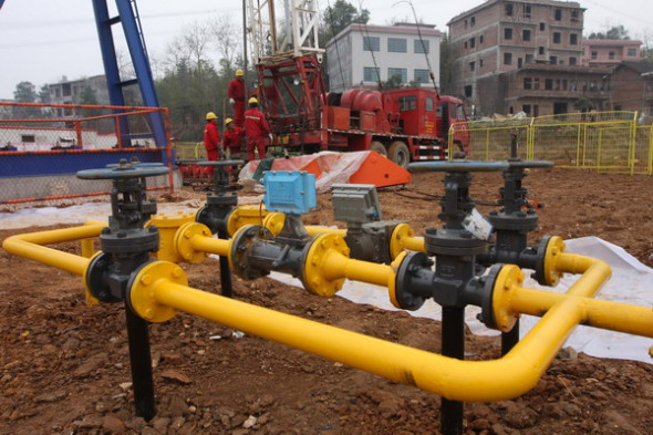 China Petrochemical Corp employees at a shale gas production site in Lianyuan, Hunan province. [Photo by Guo Guoquan / China Daily]