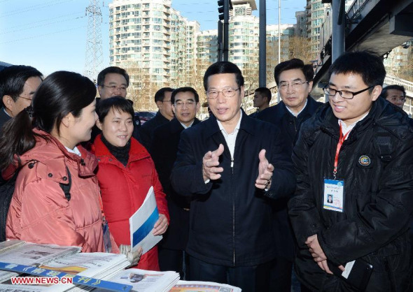 Chinese Vice Premier Zhang Gaoli talks with people involved in the third national economic census at a newsstand in Beijing, capital of China, Jan. 3, 2014. (Xinhua/Li Tao)