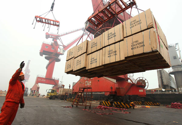 Dock workers move cargo at a port in Lianyungang, Jiangsu province. In the January-November period, the value of Chinas goods trade reached $3.77 trillion, according to the General Administration of Customs. Wang Jianmin / Xinhua