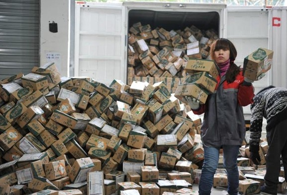 Courier company workers at a processing facility in Lin'an, Zhejiang province sort items ordered online. As more people gain access to the Internet via smartphones, small cities can become strong drivers of online shopping in China. Hu Jianhuan / For China Daily