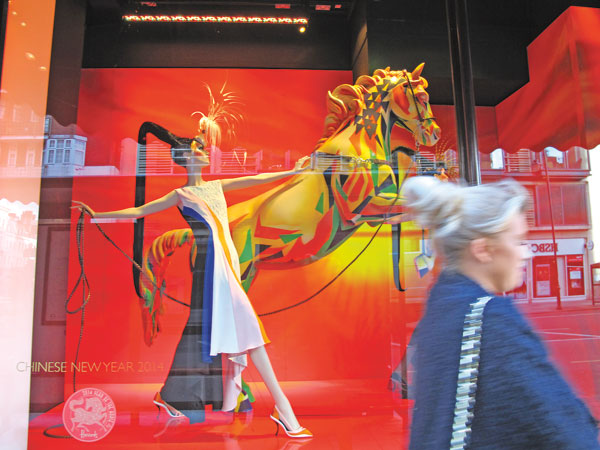 A woman passes a Lunar New Year display at Harrods department store in London on Jan 29. Zhang Chunyan / China Daily
