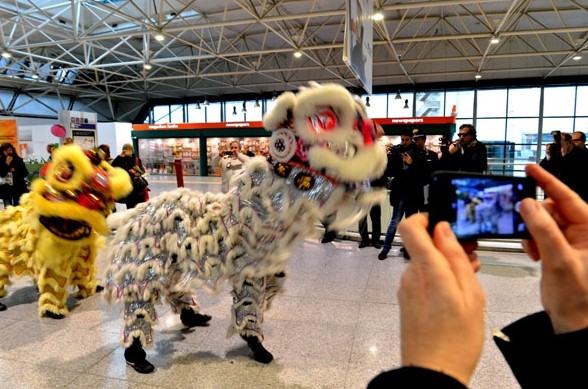 A lion dance is organized to welcome Chinese visitors to an airport in Milan. The number of Chinese visitors to Italy exceeded 500,000 in 2013, an increase of 35 percent from the figure in 2010. Most of the visitors planned to do luxury shopping there. Xu Nizhi / Xinhua  