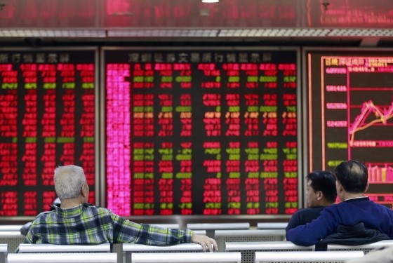 Investors at a securities brokerage in Beijing. Sectors including culture and media, aerospace, communications and electronics technology led a rally in China's stock markets on Friday. Feng Yongbin / China Daily  