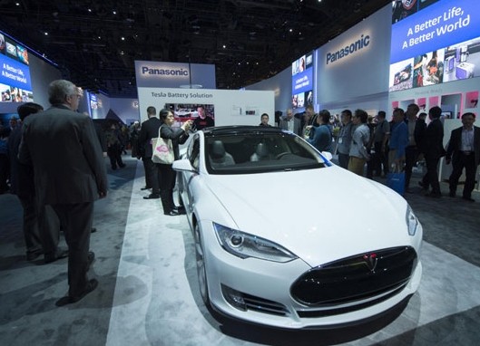 Tesla Motors Inc displaying its latest electric car at a consumer electronics show in Las Vegas. The US automaker is expanding into the Chinese market as the government encourages the use of new-energy vehicles. [Yang Lei / Xinhua]  