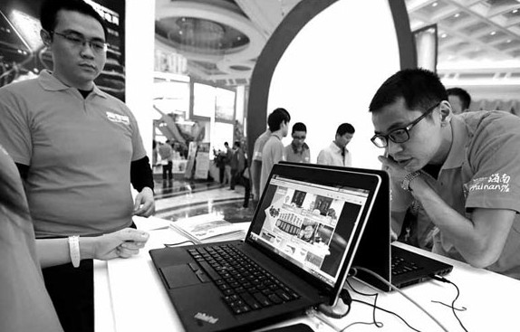 Workers from Taobao promote e-marketing at a trade show in Hainan province. [China Daily]
