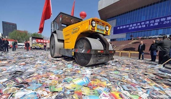Pirated publications and CDs are destroyed in Taiyuan, capital of Shanxi province, on April 25, 2013, to mark World Intellectual Property Day on April 26. [Zhan Yan / Xinhua]  