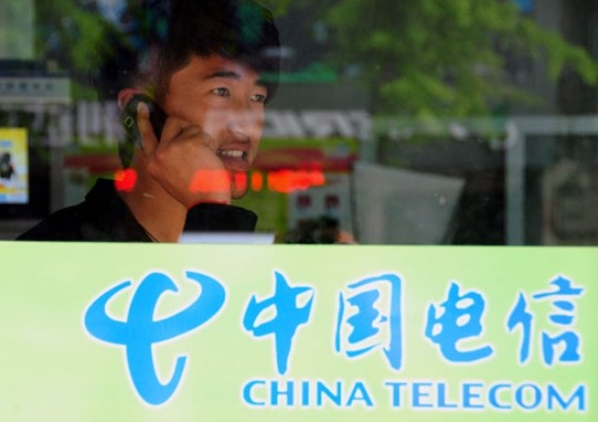 A customer makes a call in the business hall of China Telecom in Linyi city, Shandong province. Fang Dehua / for China Daily  