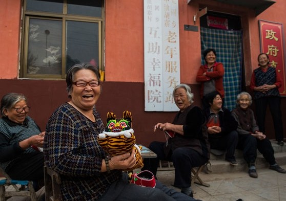 Residents of a home for the elderly in Feixiang county, Hebei province, share a laugh. [Pan Songgang / For China Daily]   