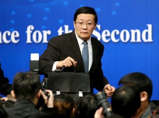 Finance Minister Lou Jiwei leaves the podium after a news conference on the sidelines of the annual session of the National People's Congress in Beijing on Thursday. Wang Jing / China Daily   