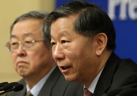 Shang Fulin (right),chairman of the China Banking Regulatory Commission,speaks at a news conference at the ongoing annual session of the National People's Congress. Wang Jing / China Daily   