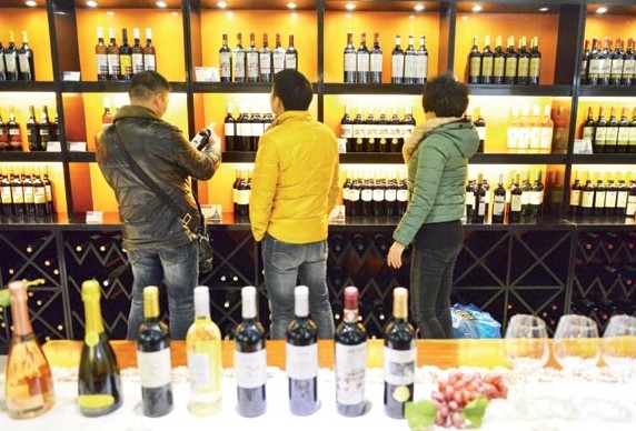 Customers select imported wine at a shopping mall in Yiwu, Zhejiang province. Lu Bin / For China Daily