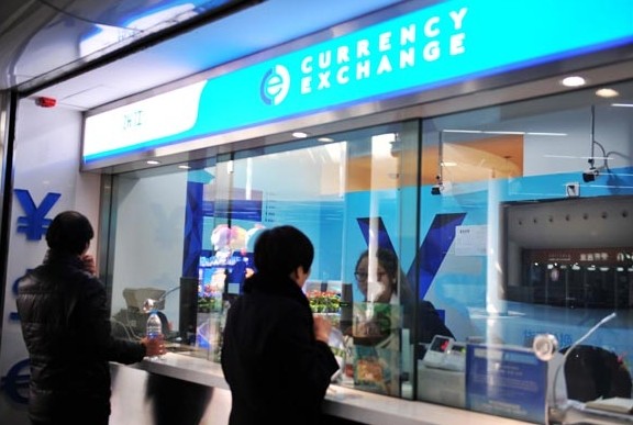 A currency exchange counter at a subway station in Shanghai. The yuan closed at 6.1781 to the dollar on Monday, down 285 basis points from Friday. Provided to China Daily   