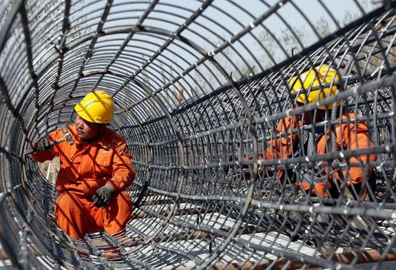 Workers prepare steel frames for a bridge on the Lianyungang-Yancheng railway in Ganyu, Jiangsu province. The State Council announced pro-growth measures on April 2, including railway investment and urban renovation programs. SI WEI/CHINA DAILY  