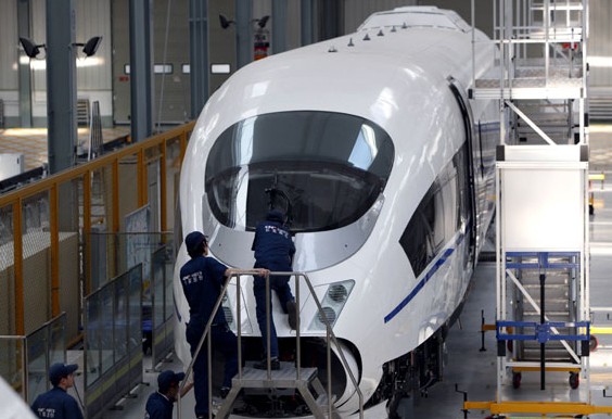 Staff of China CNR Corp check a locomotive at a workshop in Changchun. CNR Changchun started exporting trams in 1995 and now has clients spread across Australia, Brazil, Southeast Asia and the Middle East. Provided to China Daily  