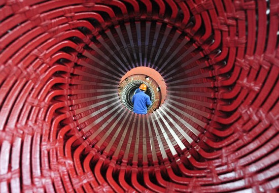 A worker installs rotor coil at a CITIC Heavy Industries Co Ltd plant in Luoyang, Henan province. The HSBC Purchasing Managers'Index slipped to 48 in March from 48.5 in February. Huang Zhengwei / For China Daily  