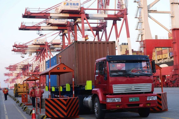 A truck carries a container at the Qingdao port in Shandong province. Organizations such as the International Monetary Fund and the World Bank have long forecast the inevitability of China's ascent to the top of the global economic ladder, but probably not until 2020 or even 2024. YU FANGPING/CHINA DAILY