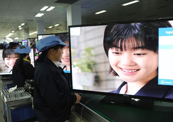 Workers test flat screen television sets on an assembly line in Lianyungang, Jiangsu province. The final reading of the HSBC Holdings Plc Purchasing Managers Index for April came in at 48.1,below the preliminary reading of 48.3. Geng Yuhe / For China Daily  