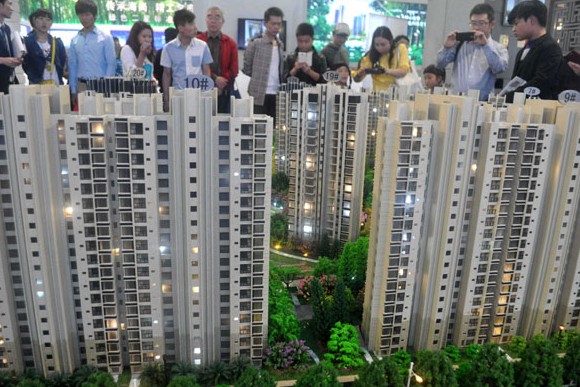 Shanghai residents ponder models of new housing projects. China's property investment growth in the first quarter slowed to 16.8 percent year-on-year from 19.9 percent in the fourth quarter last year. Yan Daming / For China Daily  