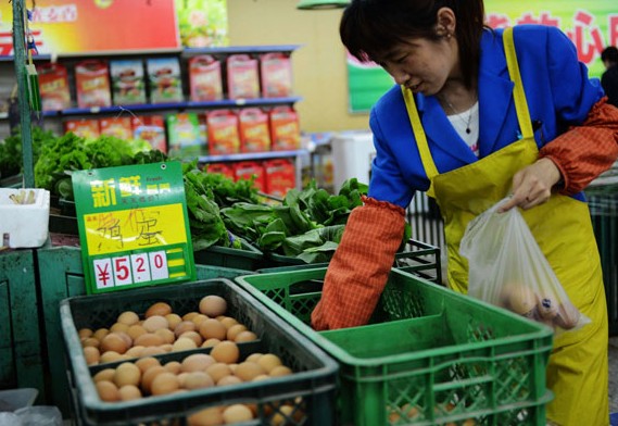 Eggs are sold at a supermarket in Qingdao, Shandong province. According to the World Bank's purchasing power parity-based calculations, China's economy was equivalent to 87 percent of the US economy in 2011. Yu Fangping / For China Daily  