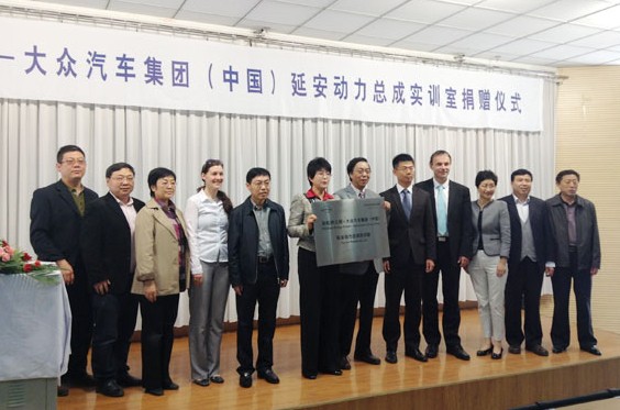 Representatives from Volkswagen Group China, Shaanxi Provincial People's Association for Friendship with Foreign Countries, and Yan'an Vocational & Technical College pose for photos at the donation ceremony in Yan'an, Shaanxi province, May 6, 2014. [Photo/ Provided to chinadaily.com.cn]  