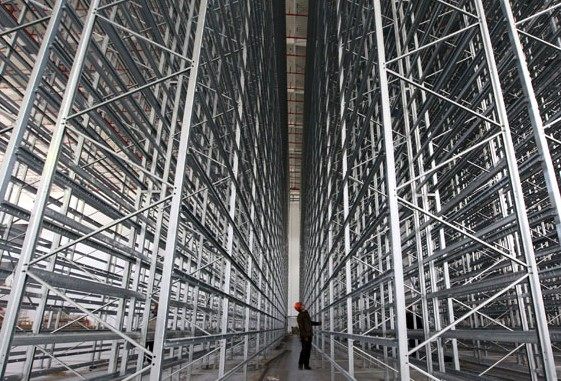 An automatic distribution center, the largest in terms of daily handling capacities in Asia, will be in operation in July in Shanghai. To cope with the e-commerce surge, as much as $2.5 trillion may need to be invested in land and warehouses over the next decade and a half, one builder said. Pei Xin / Xinhua  
