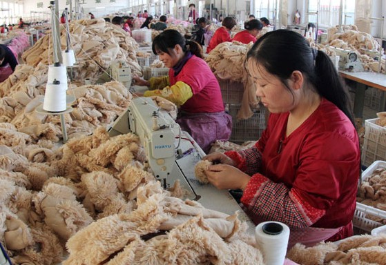 Workers produce stuffed toys at a factory in Ganyu county in Jiangsu province. Si Wei / For China Daily  