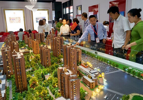 Potential homebuyers inspect models of housing developments in Beijing. Provided to China Daily
