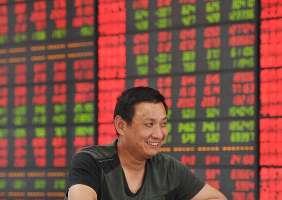 An investor at a security firm in Fuyang, Anhui province. Stocks of Chinese information technology companies jumped Wednesday on speculation that China may remove IBM Corp's servers from its banking sector. Lu Qijian / For China Daily  