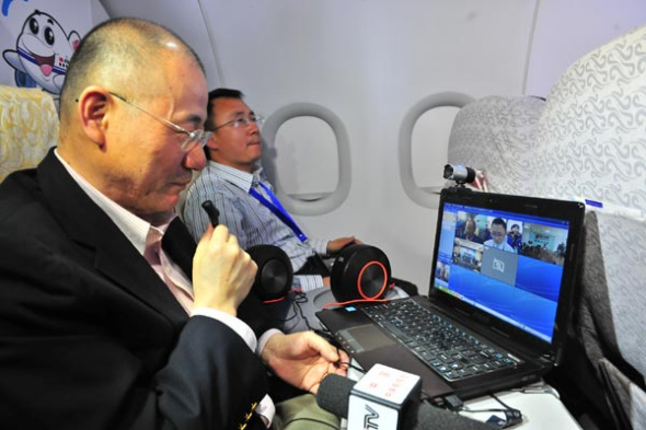An Air China official holds an Internet conference on the airliner's flight CA4116 in April. Air China and Hainan Airlines Co Ltd have sought permission to test in-flight connectivity. Photos by Wang Zemin for China Daily