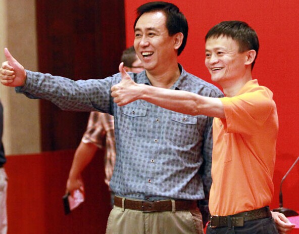 Ma Yun (right), Alibaba founder and chairman, and real estate tycoon Xu Jiayin celebrate after signing a deal in Guangzhou on Thursday that will see Alibaba Group pay 1.2 billion yuan ($192 million) for a 50 percent stake in China's top soccer club Guangzhou Evergrande, previously wholly owned by Xu's property developer Evergrande Group, which gives the club its name. [Photo / China Daily]