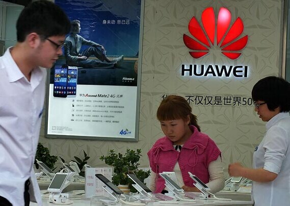 Two shoppers in Yichang, Hubei province, examine Huawei-brand mobile phones. Russia's MegaFon chose Huawei as a partner to speed mobile networks in Russia. Liu Junfeng / For China Daily