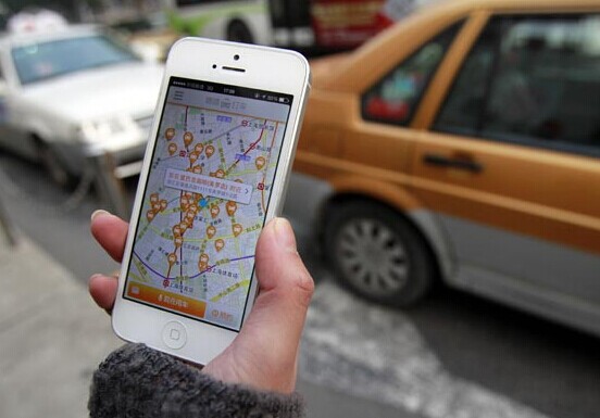 A customer checks his smartphone app that eases finding a taxi. Ding Ding / China Daily