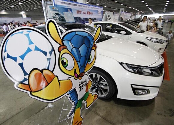 Fuleco, the official mascot of the 2014 FIFA World Cup in Brazil, is displayed at an automobile showroom in Nanjing, Jiangsu province. The World Cup has spurred China's soccer gambling sector, with game-related sales hitting a record high. [Photo/China Daily]  
