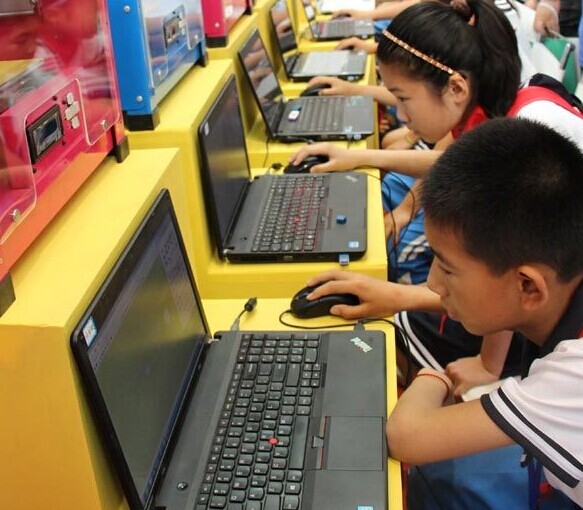 Children experience 3-D printing technology at the booth of Qingdao Unique Products Develop Co Ltd, a local maker of 3-D printers, at the 2014 World 3-D Printing Technology Industry Conference & Exhibition. Provided to China Daily