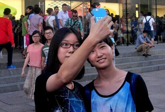 Two women in Shanghai take photos with a newly bought iPhone. Apple Inc suppliers in China will reportedly begin mass production of its largest iPhones ever next month. Yan Daming / For China Daily