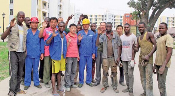 Chinese and African workers employed by Beijing Construction Engineering Group to build the tallest building in the Republic of Congo. Zhang Wei / China Daily