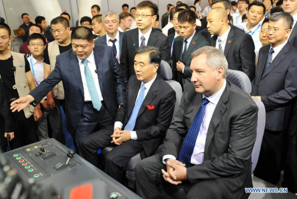 Chinese Vice Premier Wang Yang (2nd R front) and Russian Deputy Prime Minister Dmitry Rogozin (1st R front) visit the first China-Russia Exposition after attending the opening ceremony of Russian pavilion in Harbin, capital of northeast China's Heilongjiang Province, June 30, 2014. (Xinhua/Wang Jianwei) 