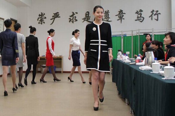 Applicants for flight attendant positions are tested by the China United Airlines Co Ltd in Beijing in March. China United will be the first State-owned low-cost airline to operate in China. Wang Zhuangfei / China Daily  