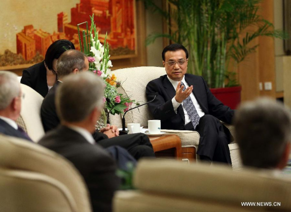 Chinese Premier Li Keqiang attends a seminar held with delegates attending the second Global CEO Council roundtable summit in Beijing, capital of China, July 9, 2014. (Xinhua/Liu Weibing) 