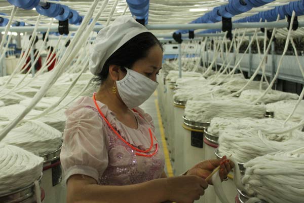 A worker at a local textile mill in Xinjiang. The autonomous region, which produces about 60 percent of China's cotton with less than 40 percent of the country's cotton-growing area, plans to create jobs for 1 million people for the region's textile industry within the next decade. Gao Bo / China Daily