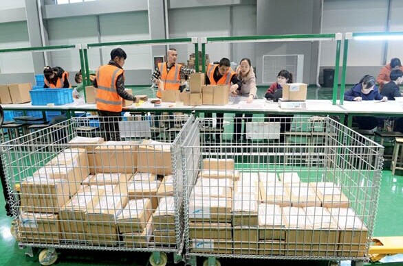 Workers pack goods for delivery in a warehouse in Ningbo free trade zone. CHINA DAILY
