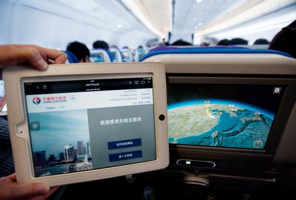 Under a test operation, some China Eastern Airlines passengers will be invited to use Chinas first onboard Wi-Fi service free from today until the end of September on flights between Shanghai and Beijing. Photo/Shanghai Daily