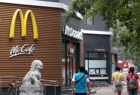 People walk past a McDonald's fast-food restaurant in Beijing. Provided to China Daily