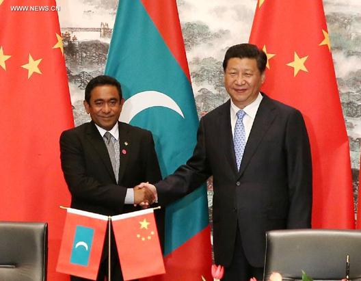 Chinese President Xi Jinping (R) shakes hands with President of the Maldives Abdulla Yameen during the signing of a number of cooperative documents in Nanjing, capital of east China's Jiangsu Province, Aug. 16, 2014. (Xinhua/Pang Xinglei)