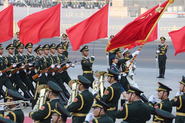 The Guard of Honor of the People's Liberation Army and the Military Band of the PLA, wearing a new type of uniform, perform at the welcoming ceremony attended by President Xi Jinping and visiting Uzbek President Islam Karimov at the Great Hall of the People in Beijing on Tuesday. Wu Zhiyi / China Daily  