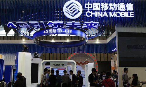 People visit the stand of China Mobile during an exhibition in Nanjing, East China's Jiangsu Province