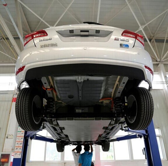 Engineers examine the battery of an electric car manufactured by Beijing Automobile Industry Co. [Photo/China Daily]  