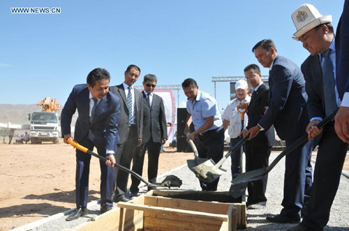 Kyrgyz First Vice Prime Minister Tayirbek Sarpashev (1st L) and Sun He (3rd R), business counselor with the Chinese Embassy in Kyrgyzstan, attend the ground-breaking ceremony of a cement plant in Kemin, Chui province, Kyrgyzstan, Aug. 29, 2014. A ceremony was held Friday to mark the ground-breaking event for a new cement plant with Chinese investment in northern Kyrgyzstan. The projected cement plant, believed to be largest in Kyrgyzstan on completion, will be located in Kemin, Chui province, about 13 kilometers east of the Kyrgyz capital, Bishkek, with the investment totaling 70 million U.S. dollars, according to Sun He, business counselor with the Chinese Embassy in Kyrgyzstan. (Xinhua)
